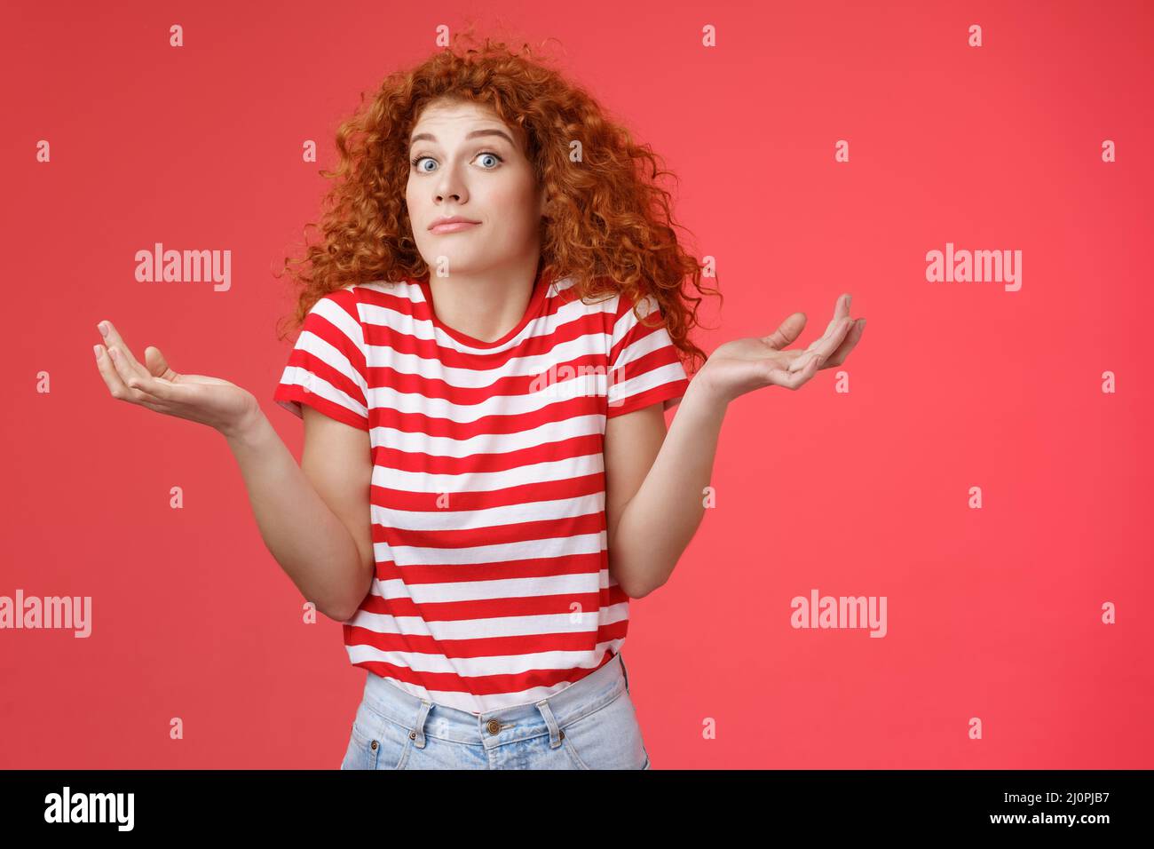 Not know ask someone else. Clueless unaware cute redhead curly-haired charming modern girl uncertain where spend summer holidays Stock Photo