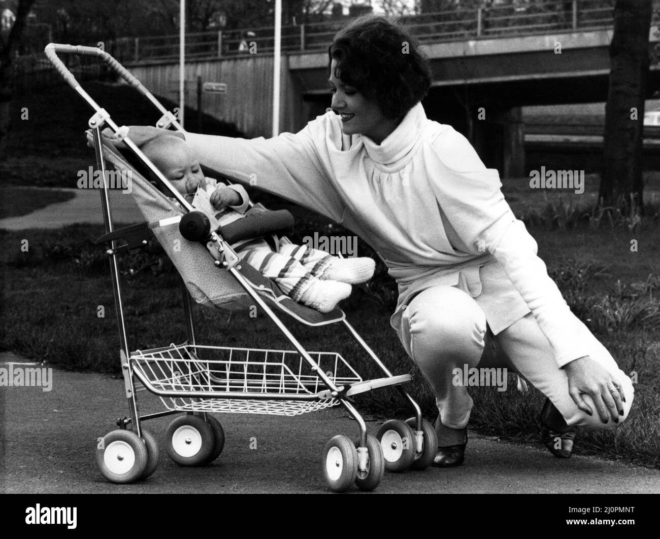 Rena pictured in a 1984-style jump suit and baby Thea relaxes in the new  McLaren Dreamer Buggy on 19th April 1984 Stock Photo - Alamy