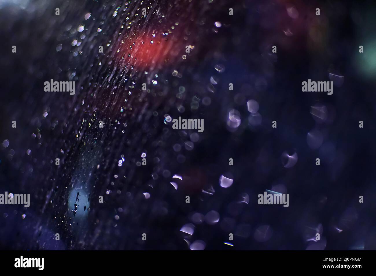 Rain droplets on car windows at night, selective focus Stock Photo