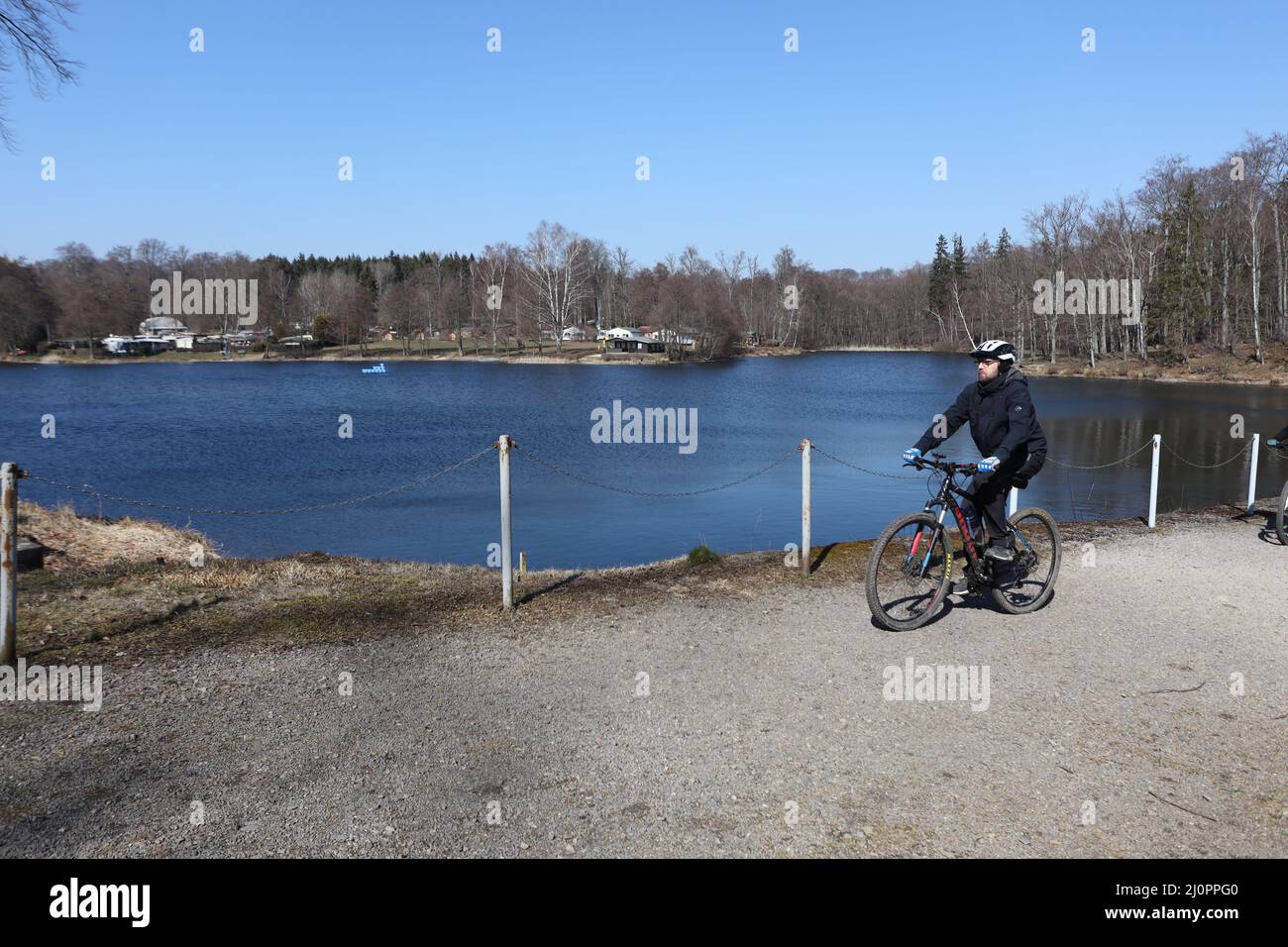 20 March 2022, SaxonyAnhalt, Gernrode A cyclist is at Bremer Teich, a