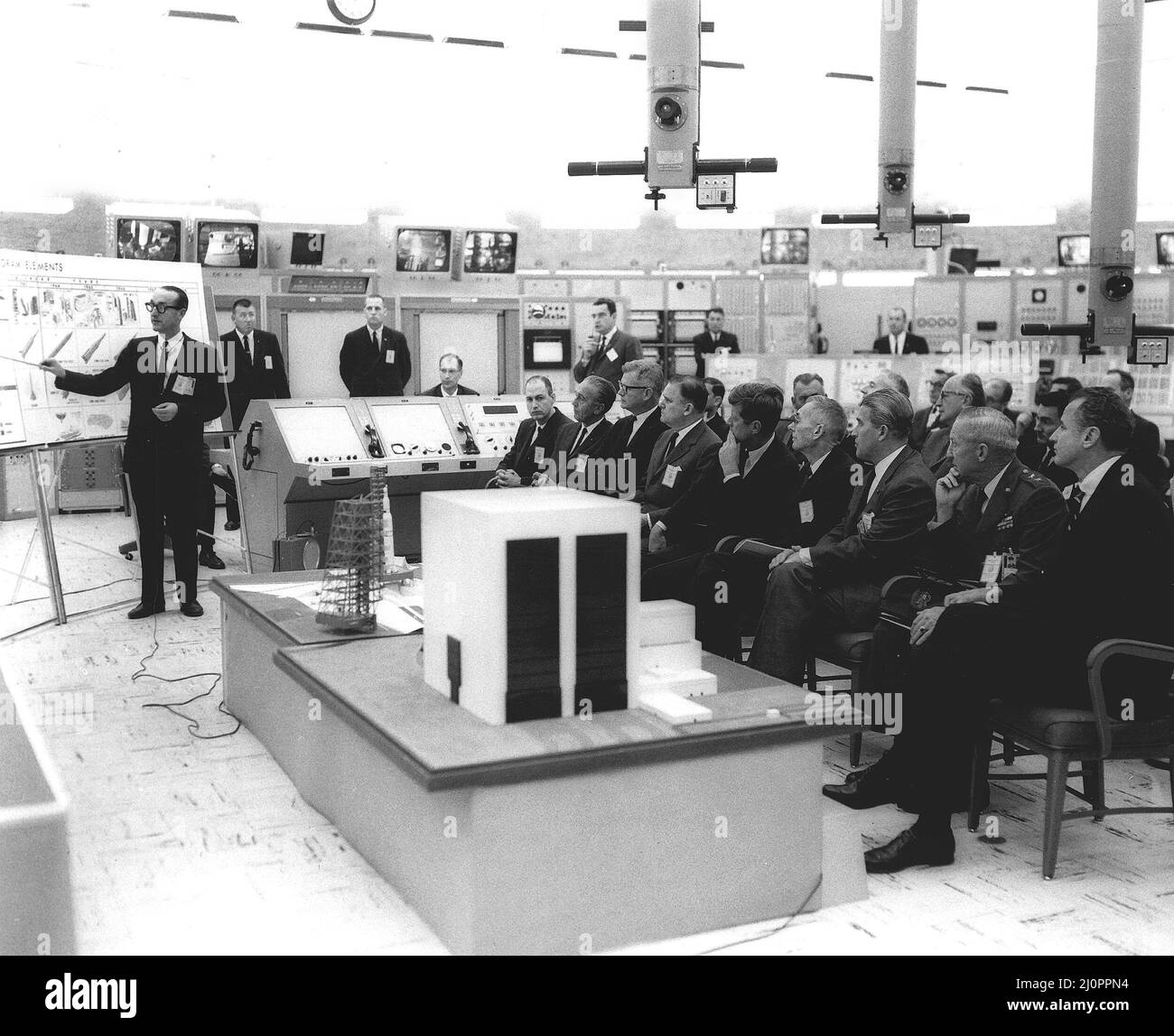 Dr. George Mueller gives Saturn V orientation to President John F. Kennedy and officals in Blockhouse 37. Front row, left to right: George Low, Dr. Kurt Debus, Dr. Robert Seamans, James Webb, President Kennedy, Dr. Hugh Dryden, Dr. Wernher von Braun, General Leighten Davis, and Senator George Smathers. Stock Photo