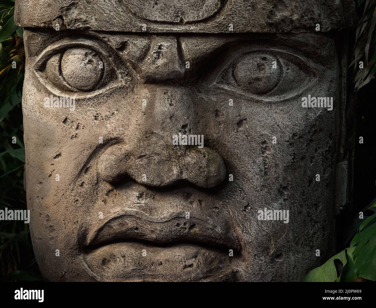 Olmec sculpture carved from stone. Mayan symbol Big stone head statue