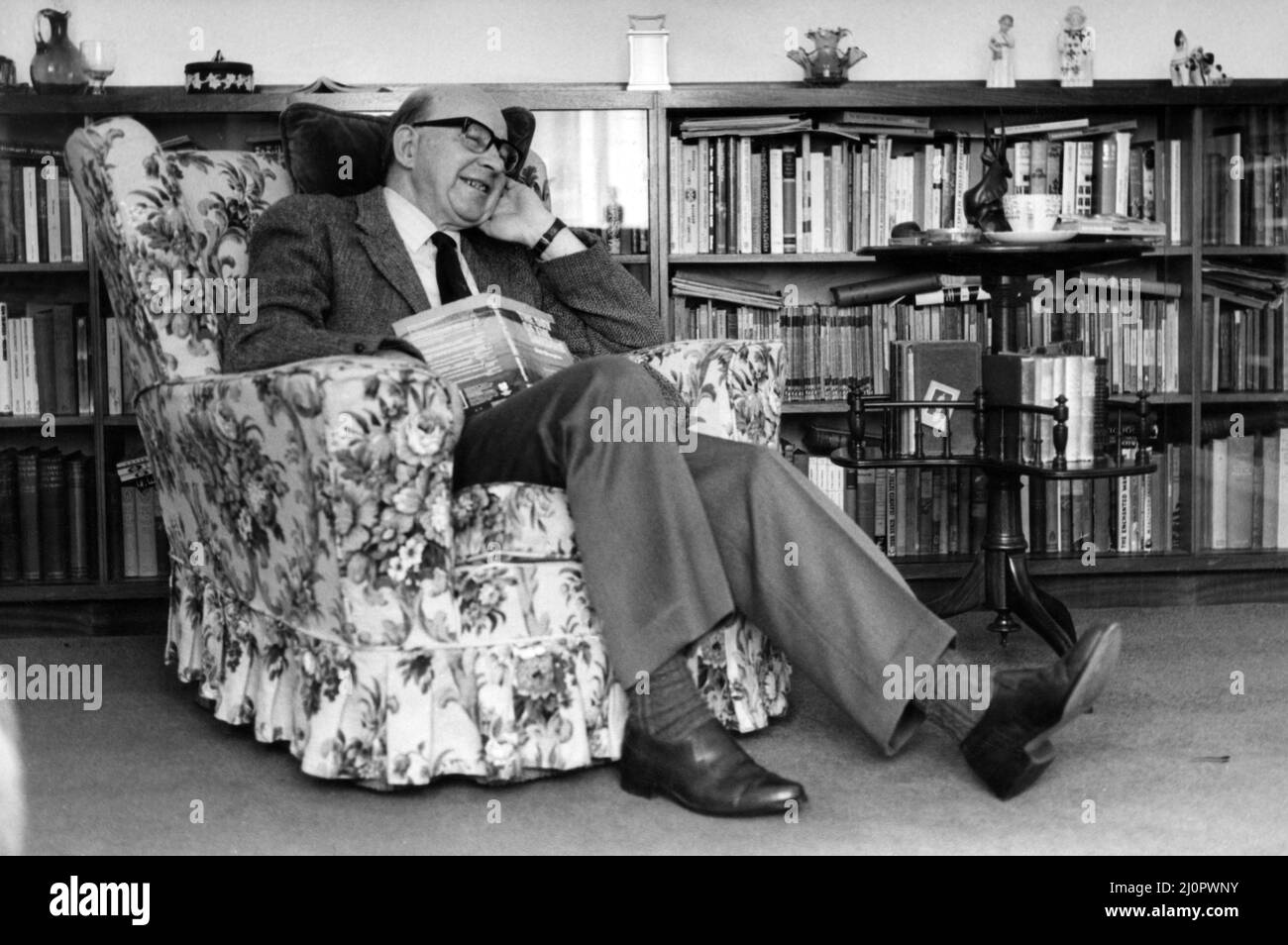 Writer Sid Chaplin, pictured sitting in a chair. Circa 1983 Stock Photo