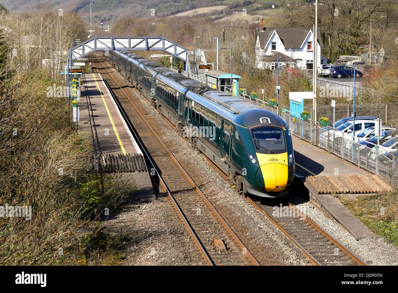 Pontyclun, Wales - March 2022:  High speed train operated by Great Western Railway passing through the railway station in the village of Pontyclun Stock Photo