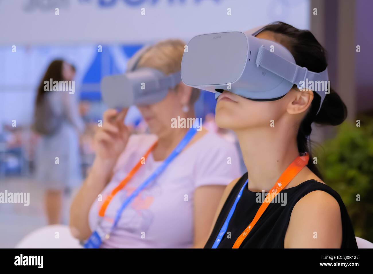 Woman using virtual reality headset at VR technology exhibition Stock Photo