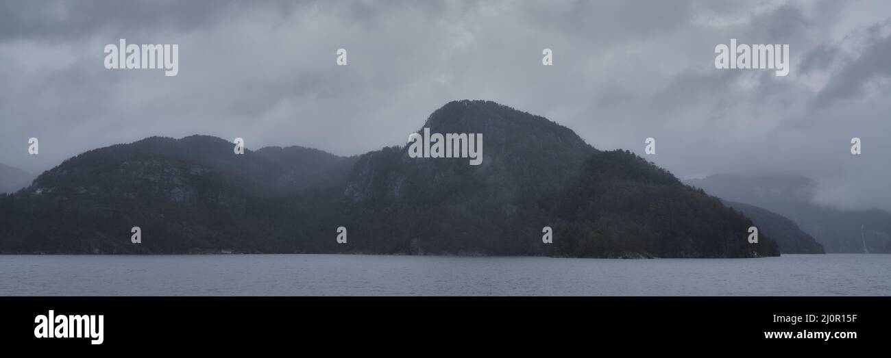 Beautiful landscape of mountains near the shore on a foggy day Stock ...