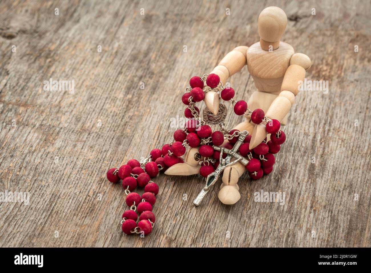 Wooden dummy holding rosary Stock Photo Alamy