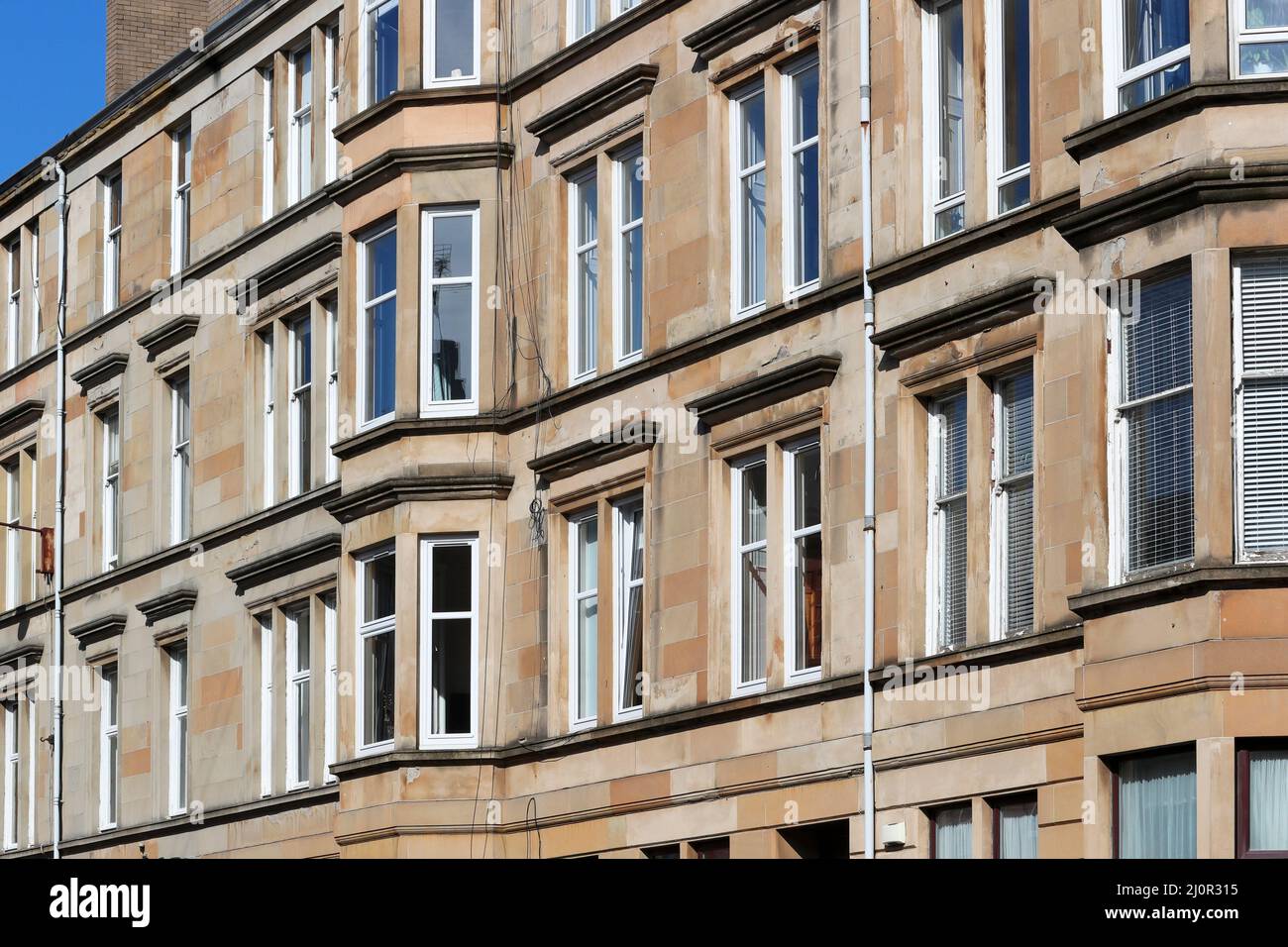 Glasgow tenement housing built with bloom coloured sandstone, Glasgow, Scotland, UK Stock Photo