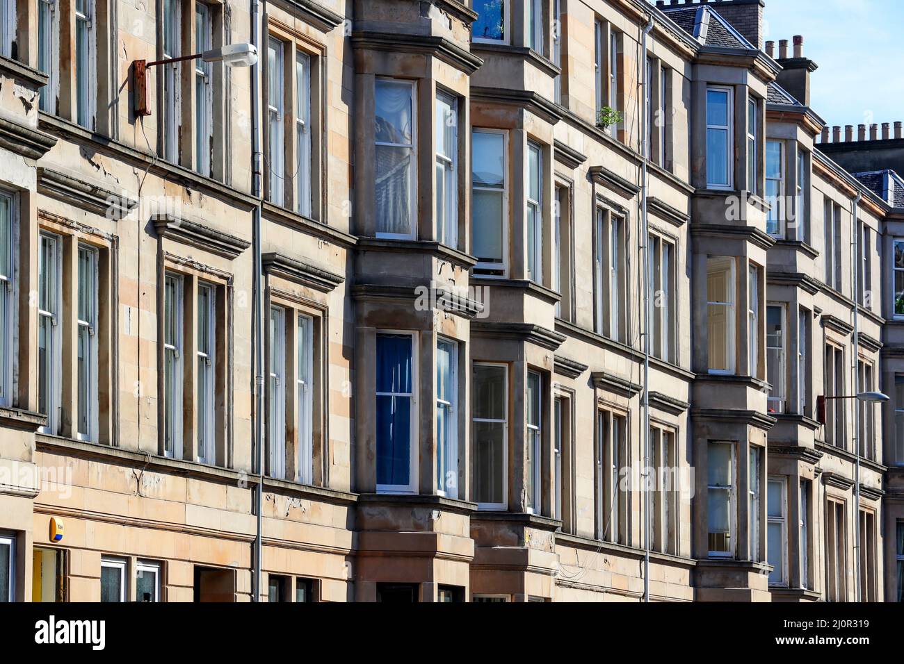 Glasgow tenement housing built with bloom coloured sandstone, Glasgow, Scotland, UK Stock Photo