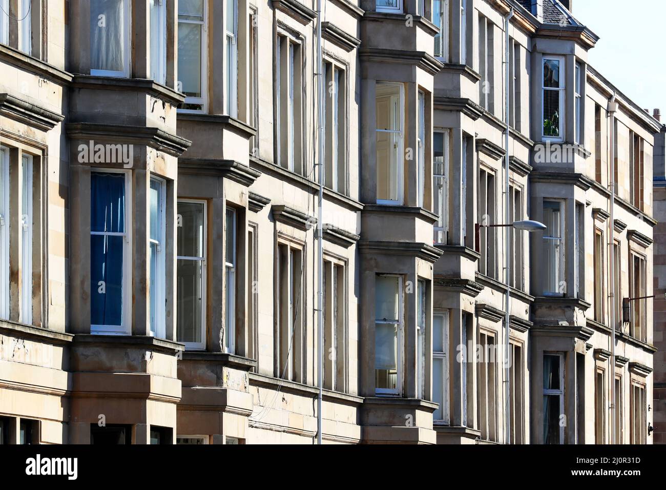Glasgow tenement housing built with bloom coloured sandstone, Glasgow, Scotland, UK Stock Photo