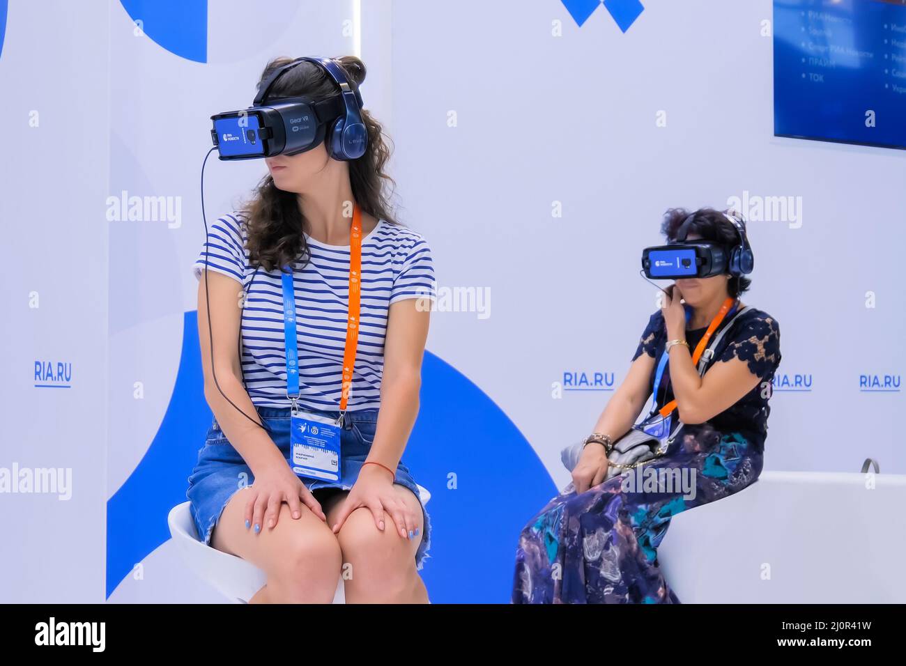 Two women using virtual reality headset at VR technology exhibition Stock Photo