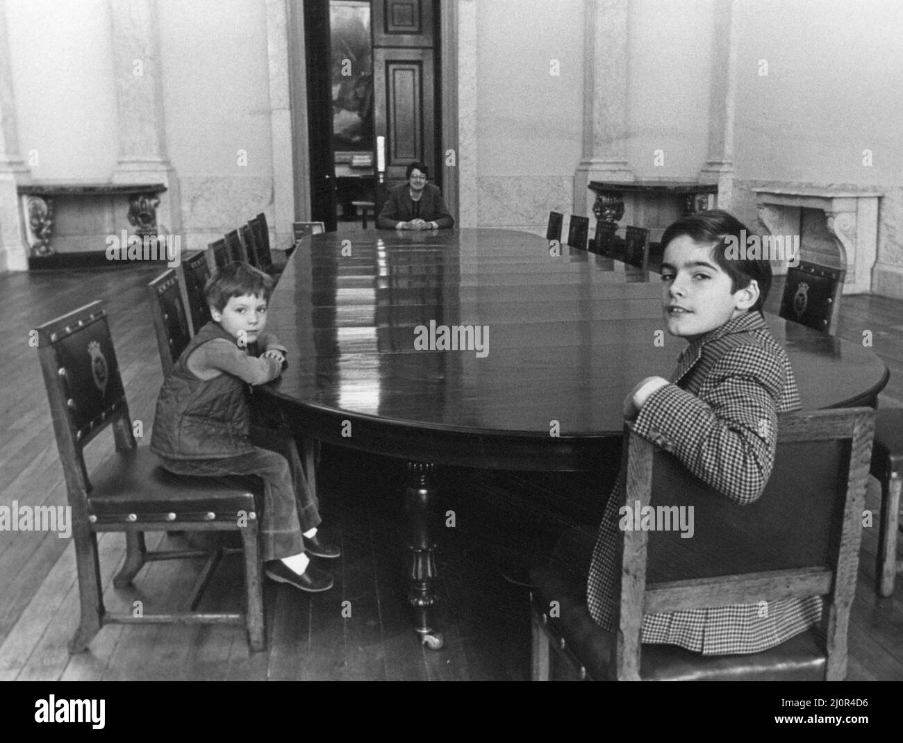 Lord Londonderry, 9th Marquess of Londonderry pictured at Wynyard Hall Estate, County Durham, 4th January 1983. Our Picture Shows ... Lord Londonderry at massive dining table with sons Frederick 10 and Reginald aged 5. Stock Photo