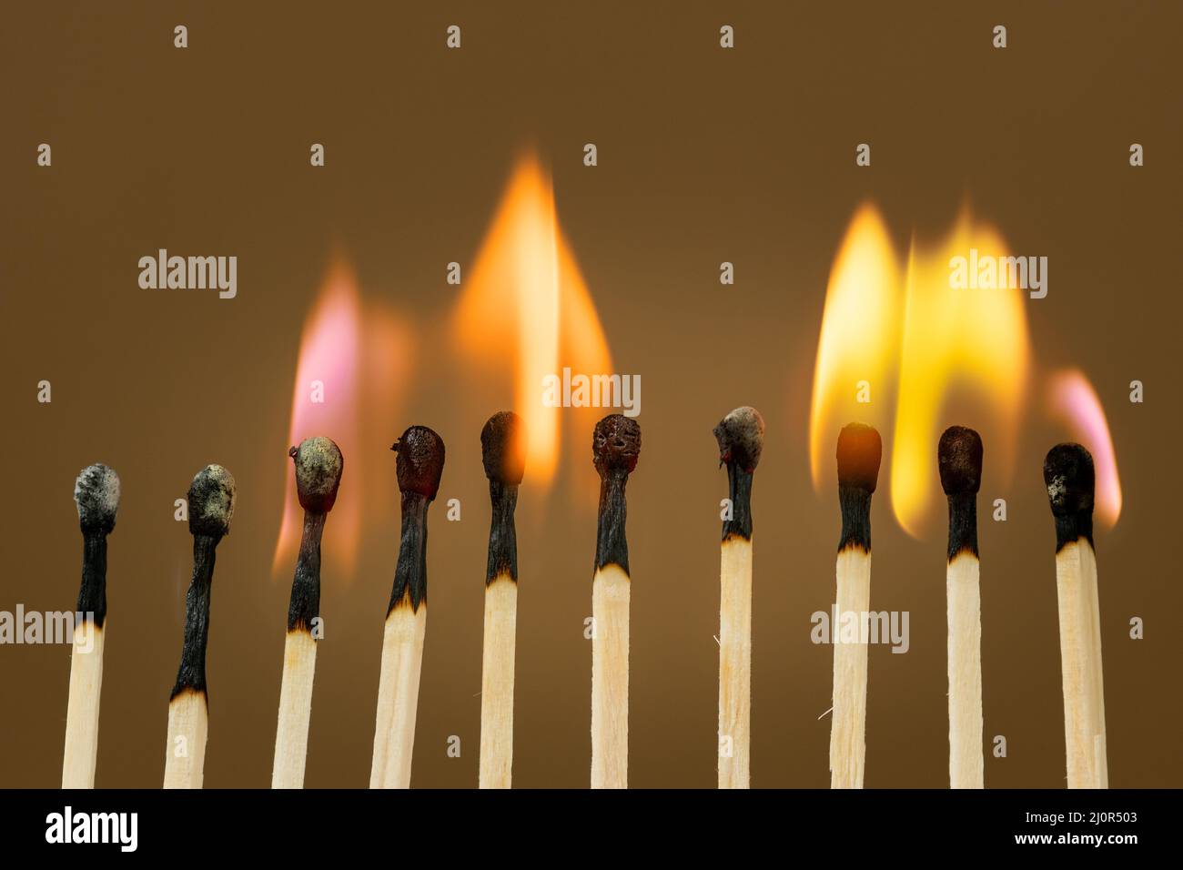 Match sticks burning with a bright colorful flames Stock Photo