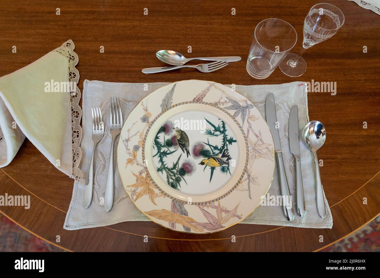 08-06-2021. Devon, UK. John James Audubon watercolour Birds of America on dining plates in Agatha Christie's summer Greenway House. Stock Photo