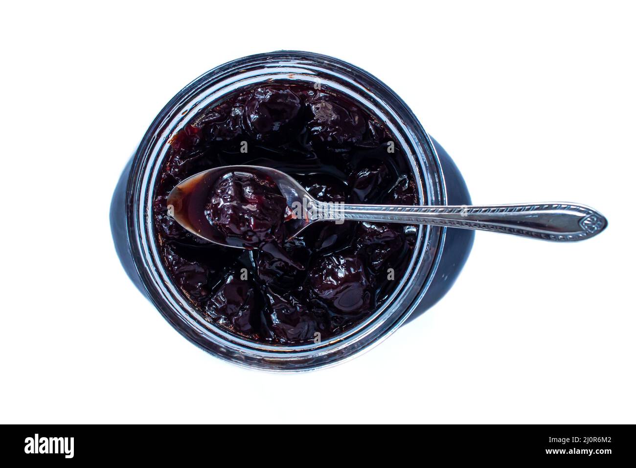 Top view of sour cherry jam in glass jar. Organic sour cherry jam