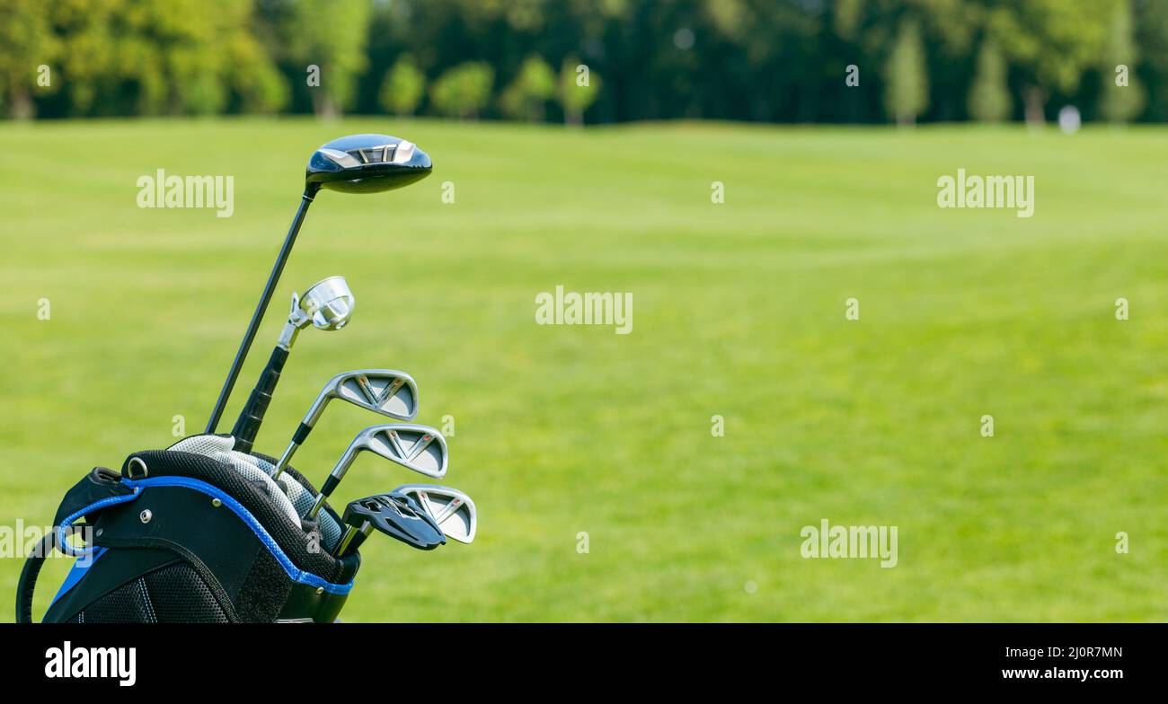Golf clubs in a golf bag isolated. Set of golf clubs for a golfer. Copy Space. green Background. Close-up Stock Photo