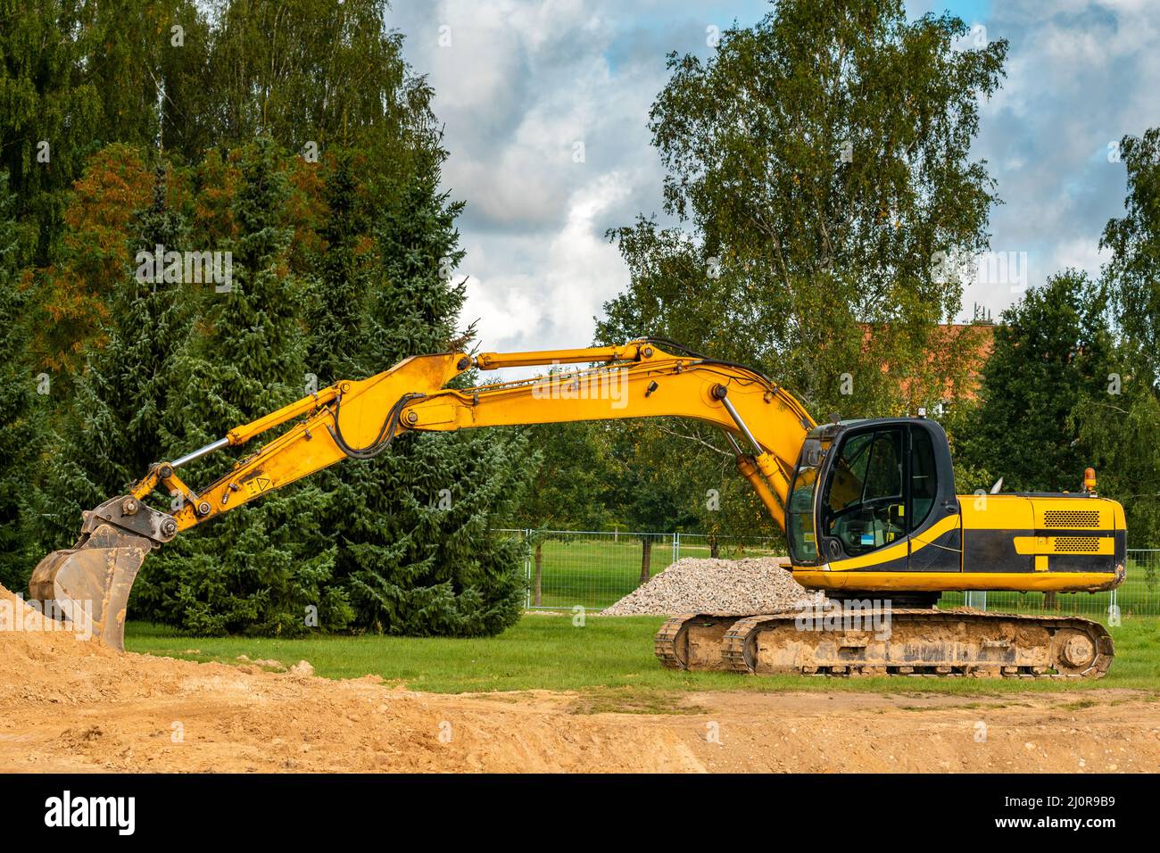 Construction excavator of yellow color on the construction site Stock ...