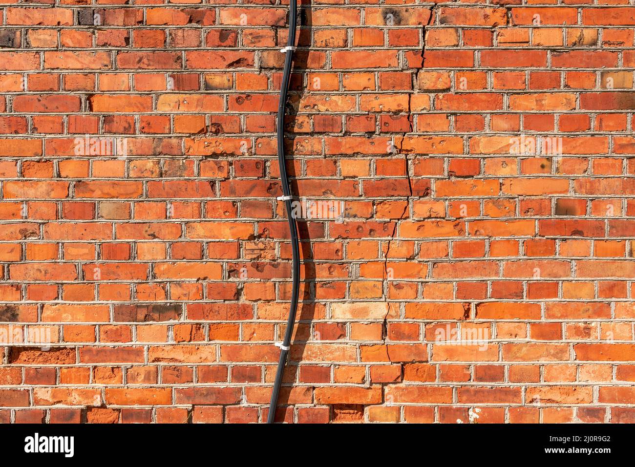 Electrical power cable wiring on old brick wall Stock Photo Alamy