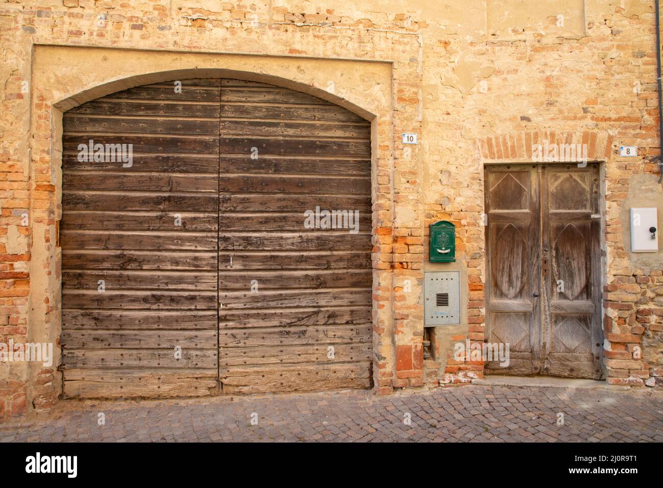 Two doors of farmhousen in centre of Cortanze, Italy Stock Photo