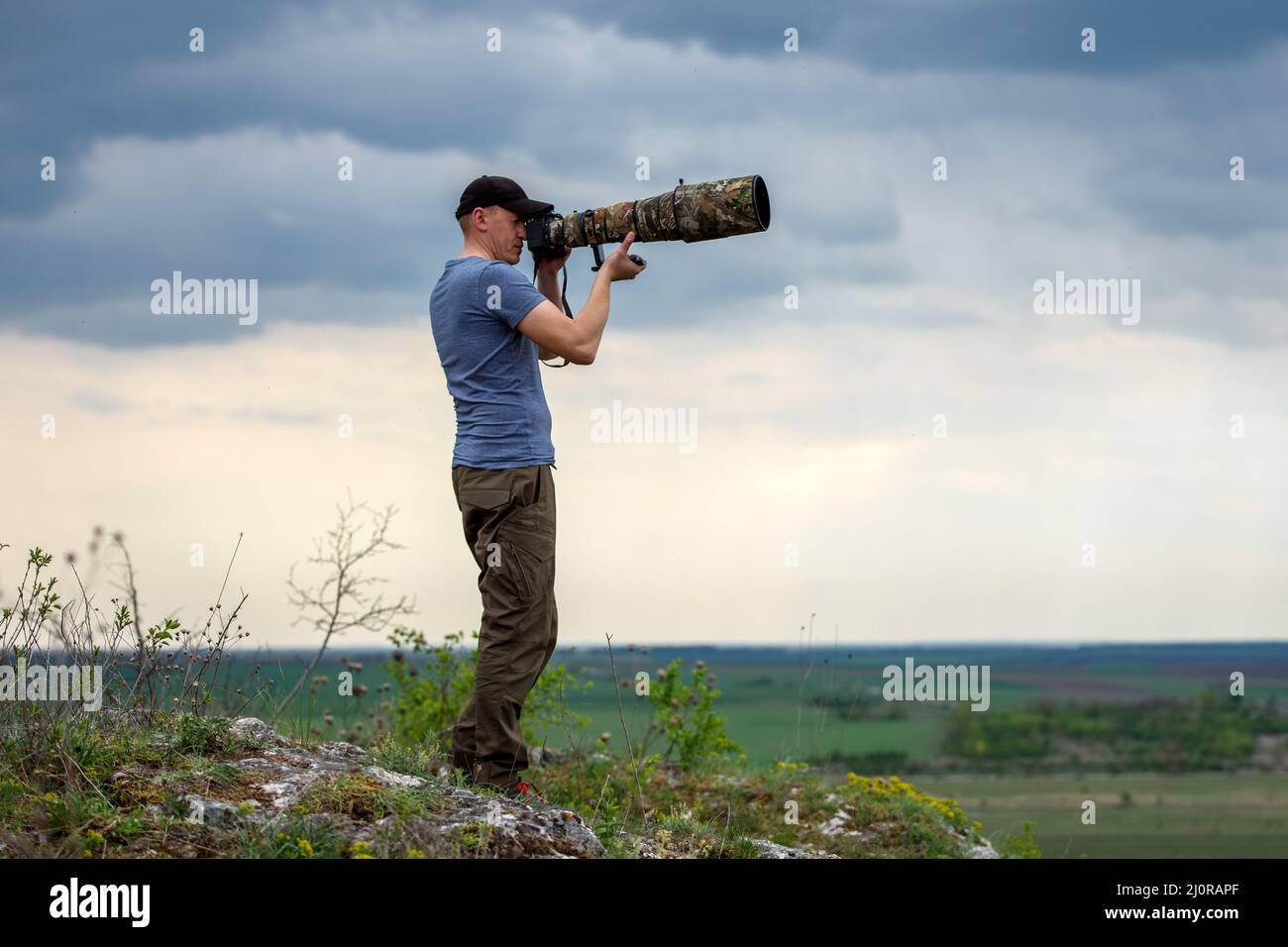 Wildlife photographer in summer time working in the wild Stock Photo