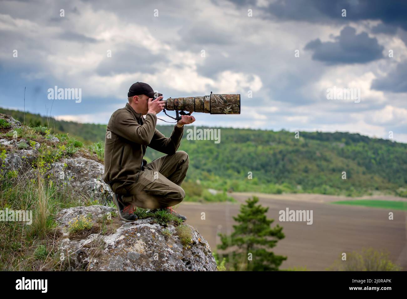 Wildlife photographer in summer time working in the wild Stock Photo