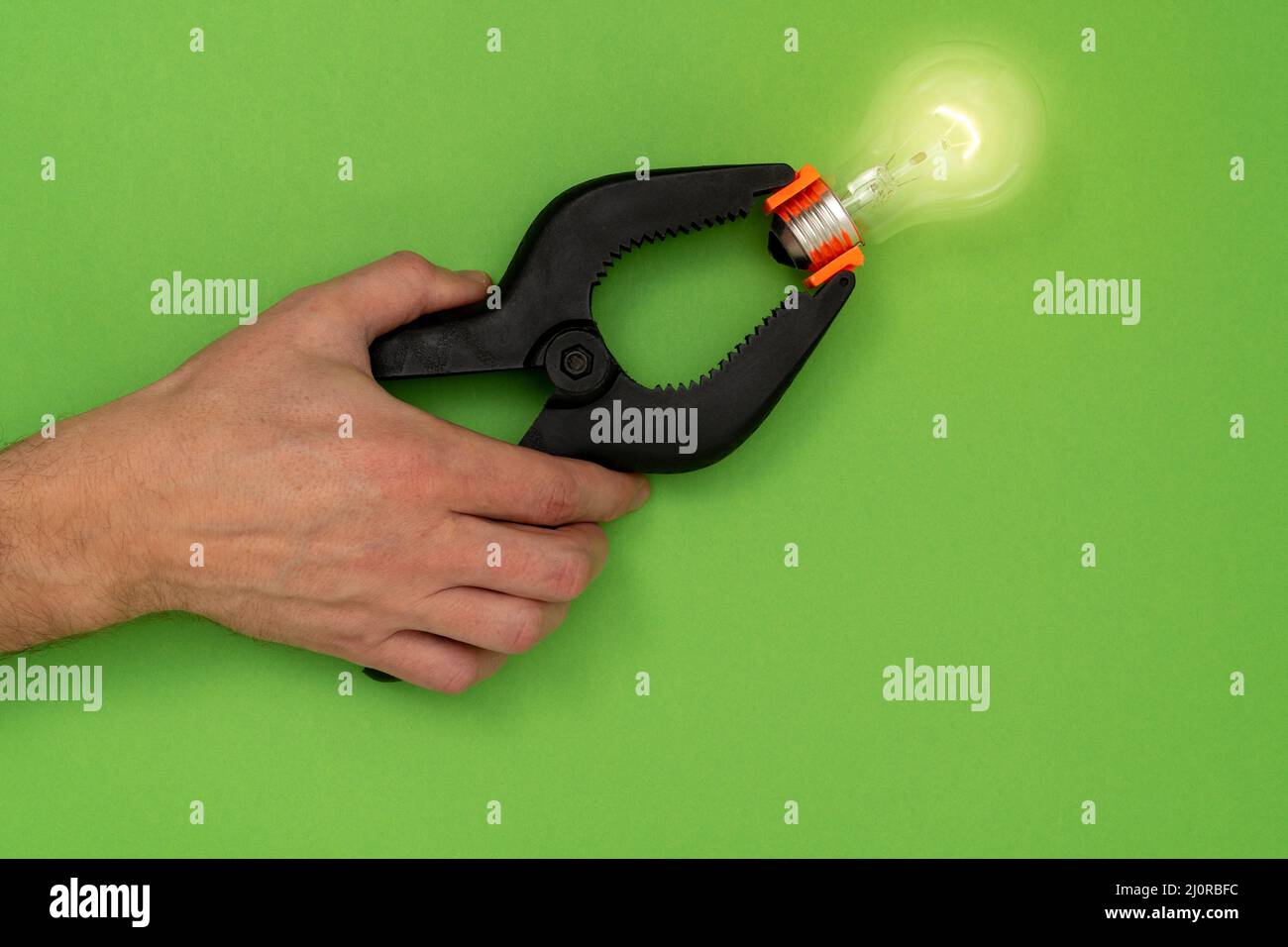 Light bulb clamped in a spring clamp Stock Photo Alamy