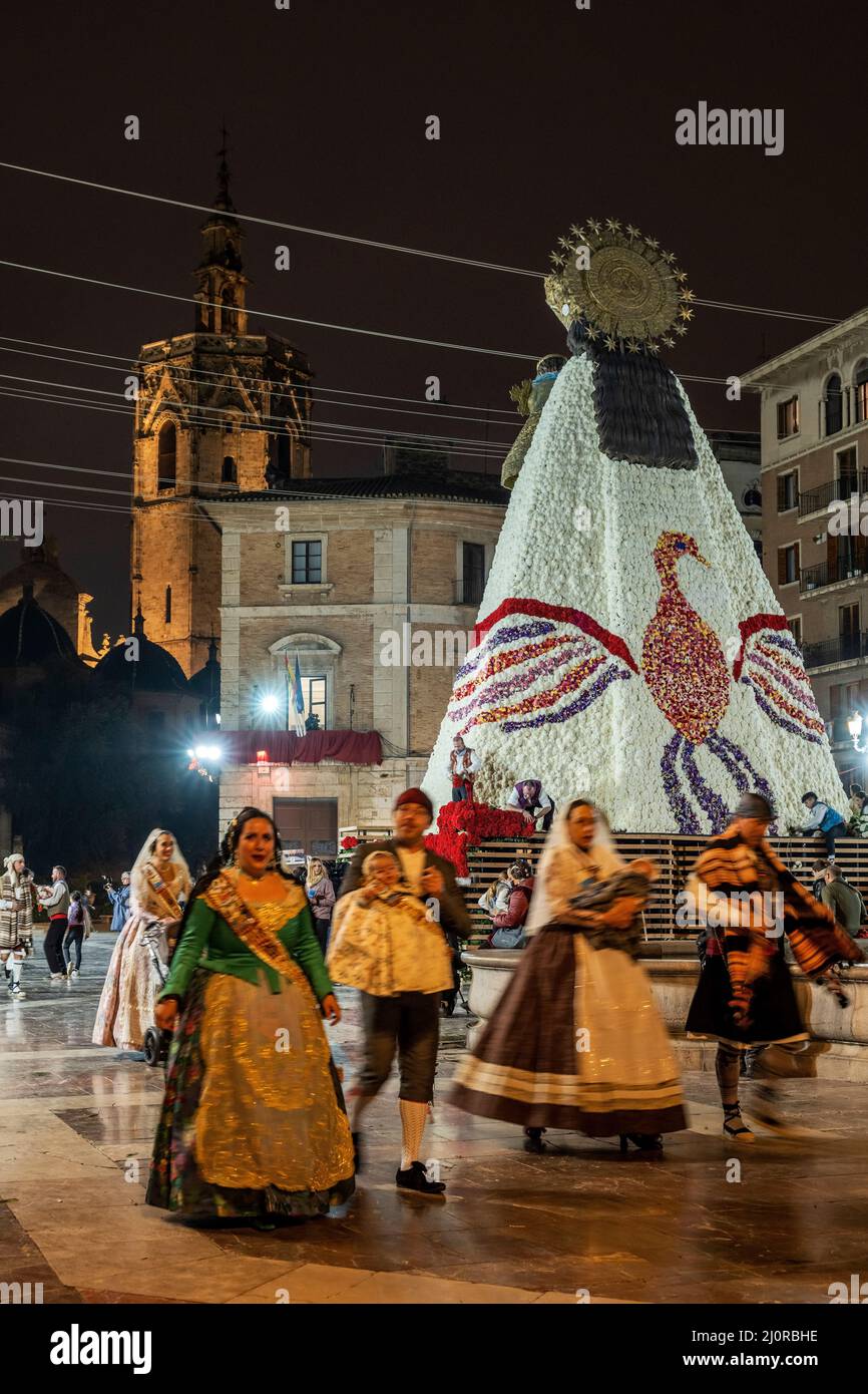 Falleros marching at the flower offering ceremony (ofrena de flors or ...