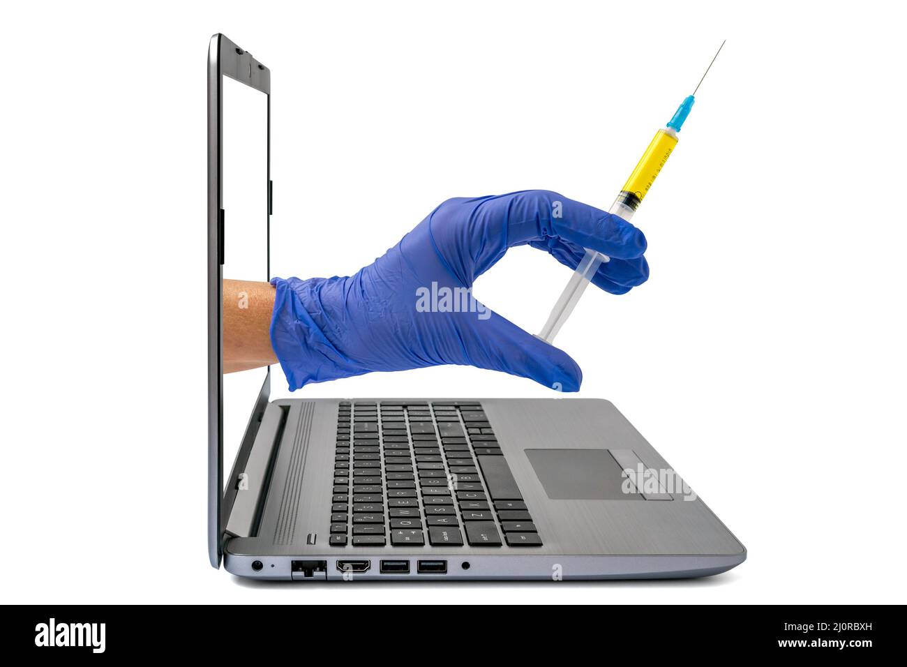 Hand holds a syringe, outstretched through the laptop screen on a white background Stock Photo