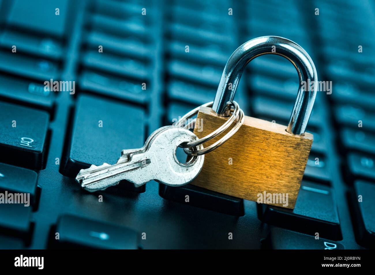 Locked padlock on laptop keyboard Stock Photo Alamy