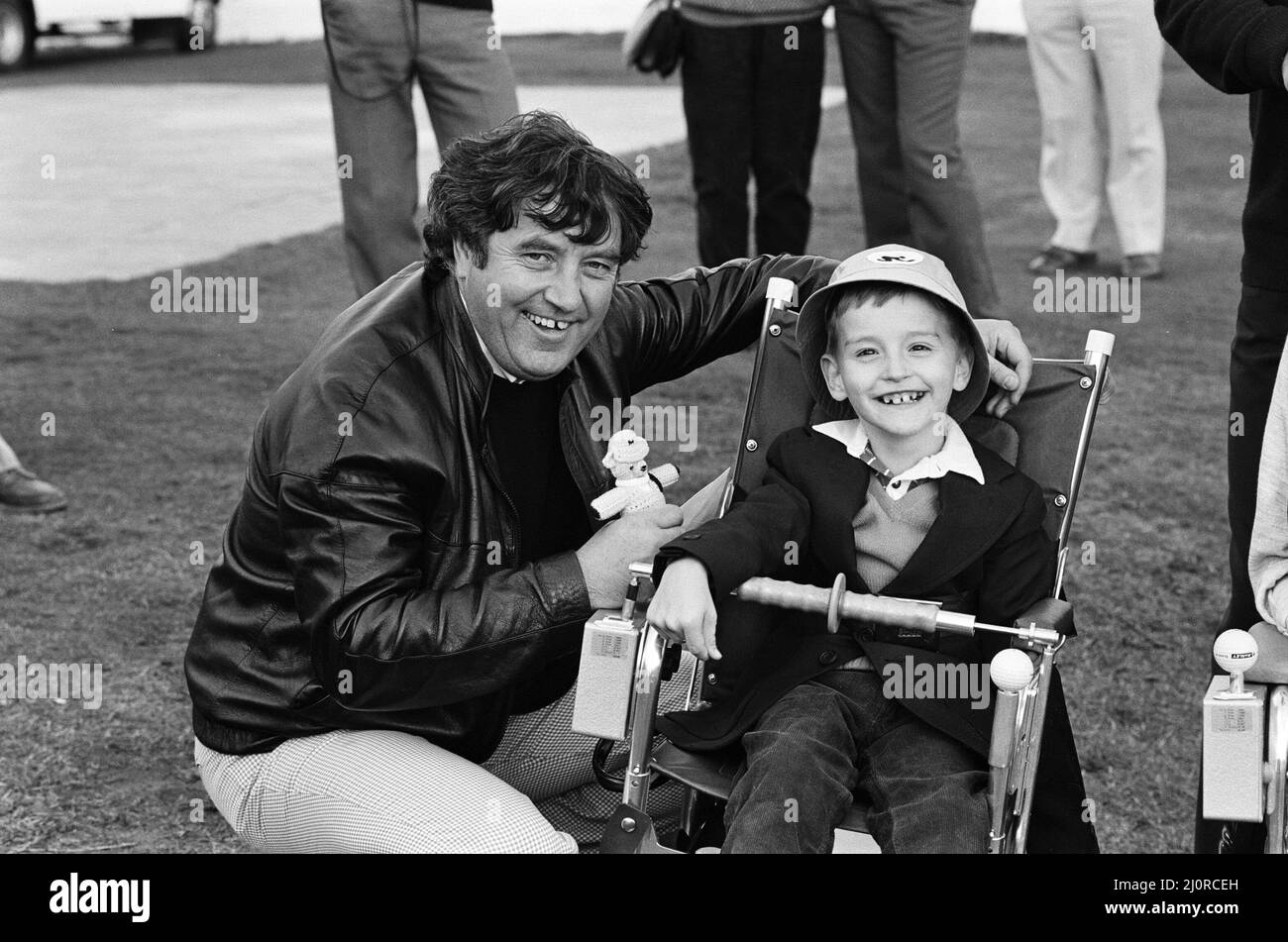 The Marley Golf Classic held at Royal Birkdale Golf Club. Jimmy Tarbuck with eight-year-old John Smith of Sandfield Park School, West Derby. 7th October 1983. Stock Photo