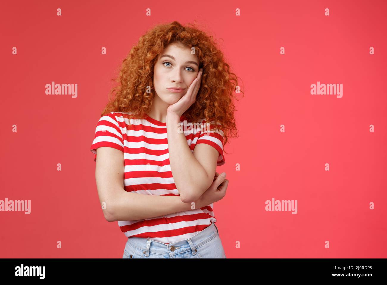 Playful redhead gorgeous girl feel sad lacking energizing party lean palm look indifferent express boredom lonely feelings atten Stock Photo