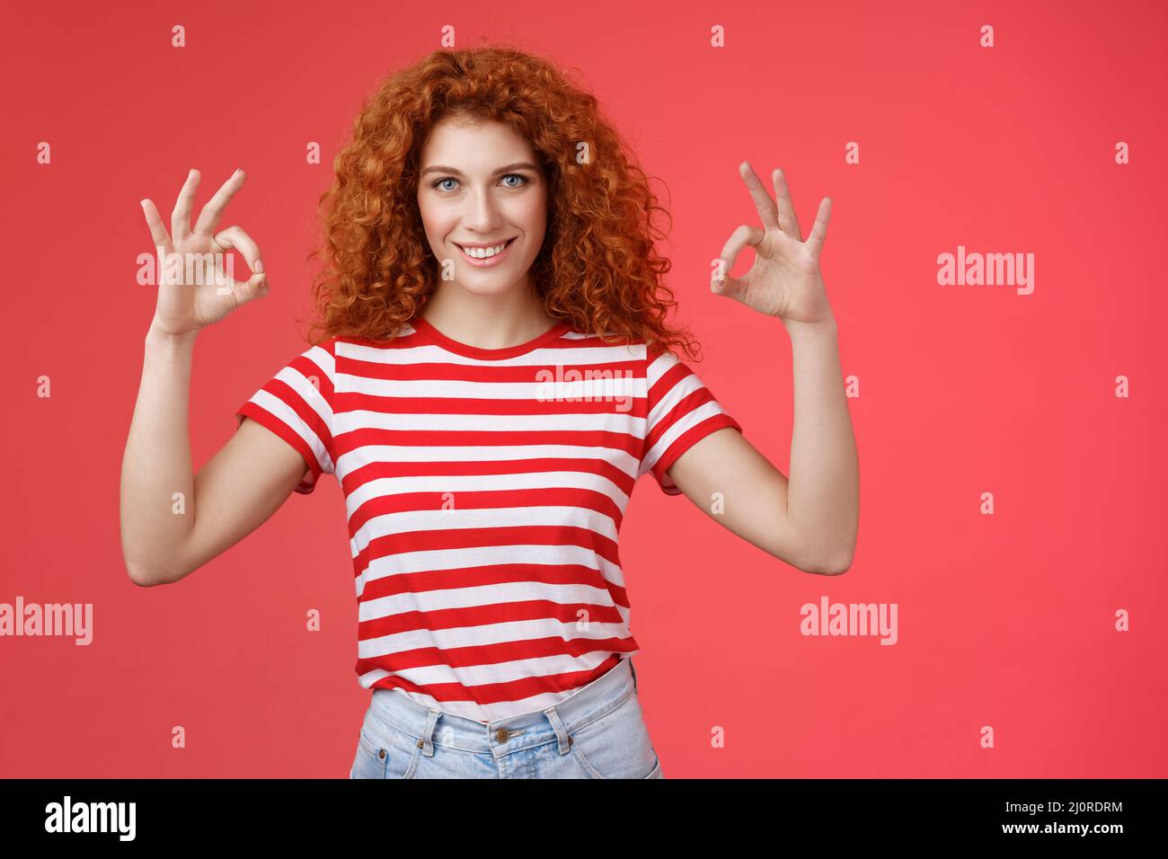 Motivated ambisious good-looking empowered young redhead curly girl assuring everything excellent show okay ok perfection gestur Stock Photo