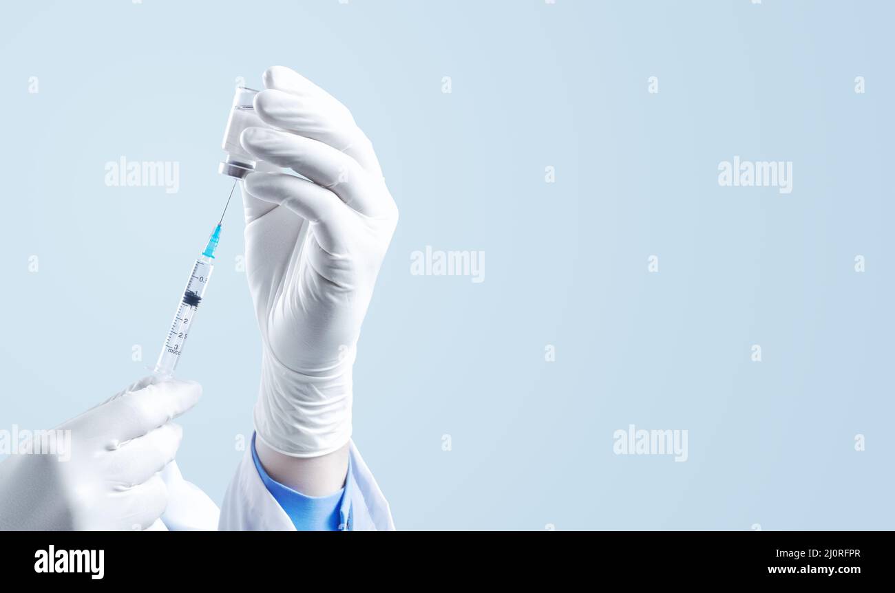 Hand holding syringe with vaccine against corona virus. Stock Photo