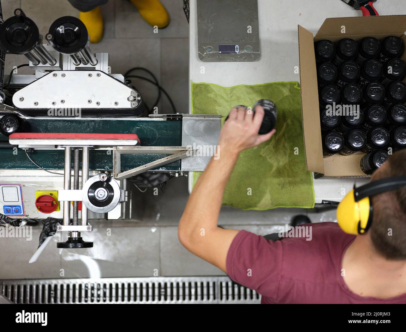 Worker packing cans of beer in a cardboard box in a brewery Stock Photo ...