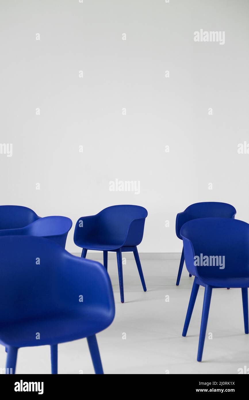 Vertical shot of the modern electric blue chairs on a white background