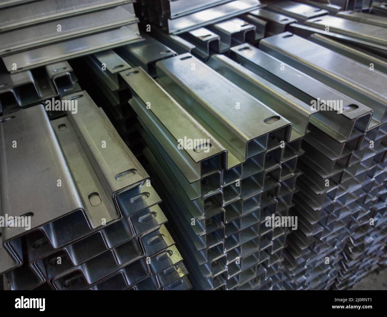 full frame view on stacks of profile bent sheet metal parts Stock Photo