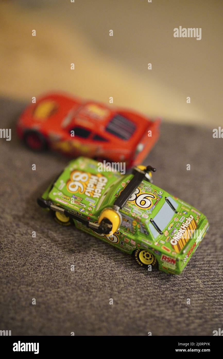 Vertical shot of Mattel Disney Pixar Chick Hicks and Lightning McQueen toy model race cars Stock Photo