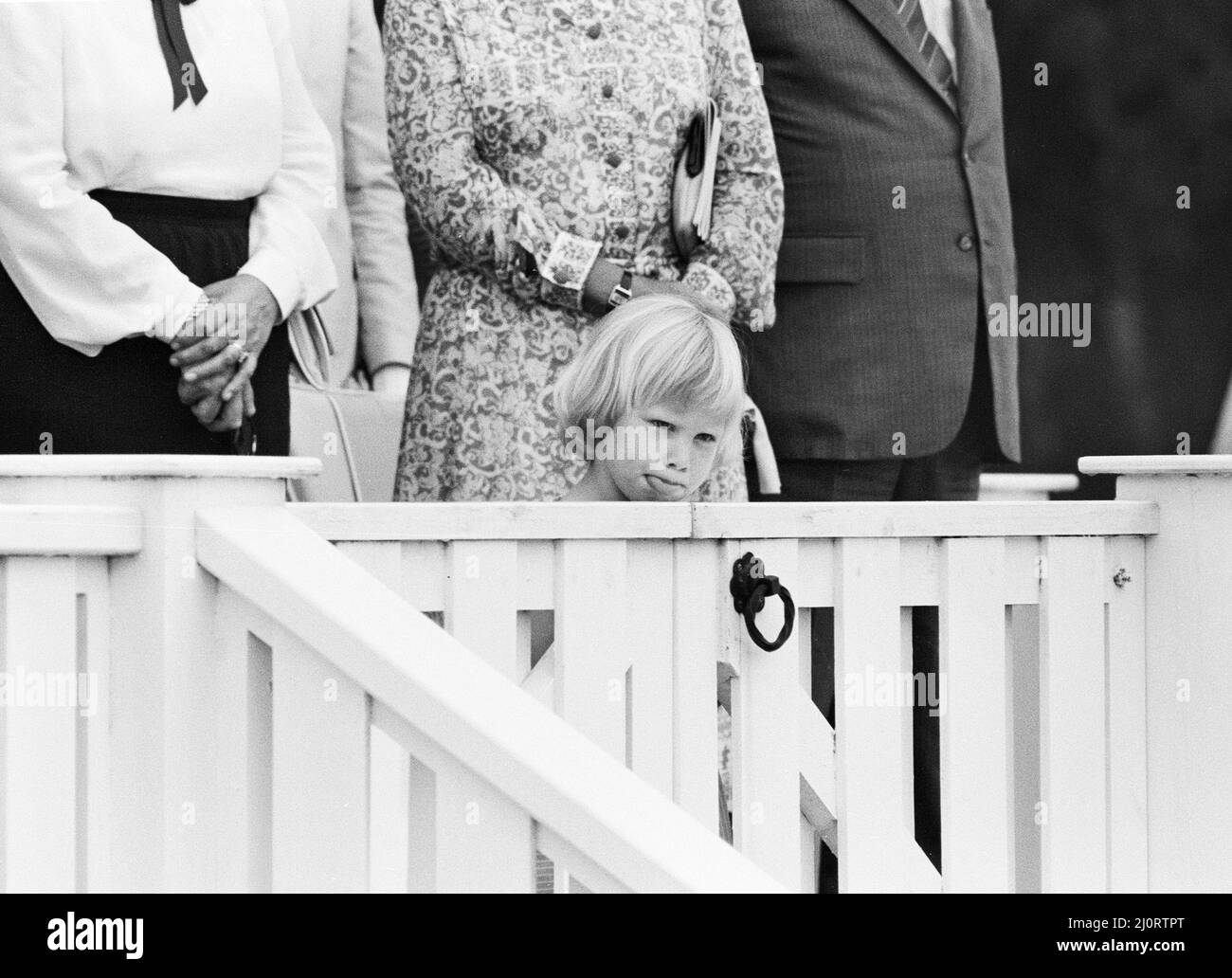 Three year old Zara Phillips, daughter of Princess Anne and Captain Mark Phillips, attending the polo match at Smith's Lawn Polo Ground in Windsor. Here she pulls a face for the photographers when she came out during tea. 17th June 1984. Stock Photo