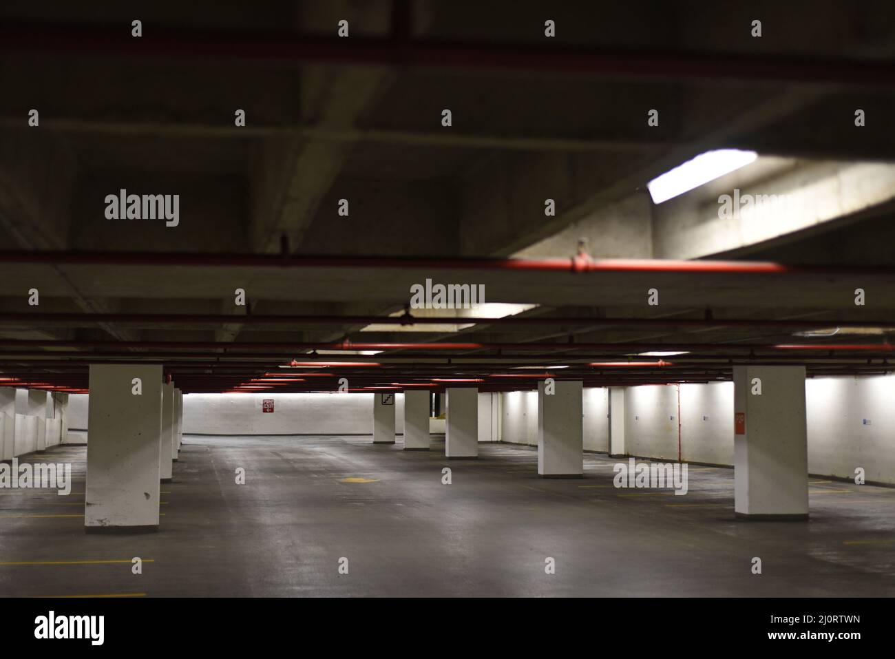 An underground parking garage with empty parking stalls Stock Photo