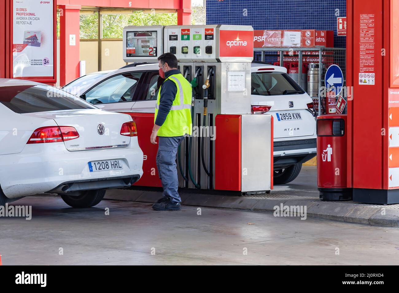Huelva, Spain - March 6, 2022: View of a petrol pump at a gas station with a car that is refueling Stock Photo