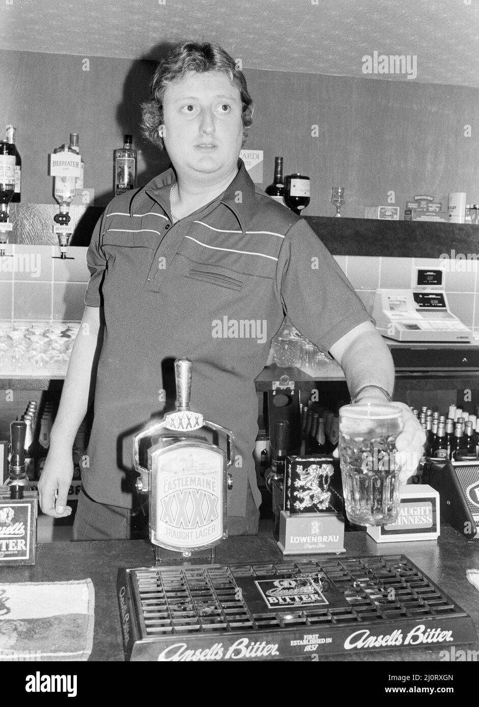 British dart player Eric Bristow pictured at the pub, serving drinks
