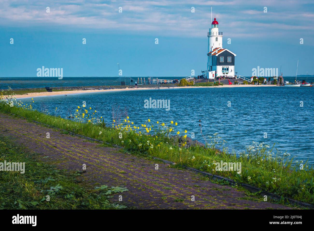Stunning wooden lighthouse on the peninsula and cozy small harbor, Marken, Netherlands, Europe Stock Photo