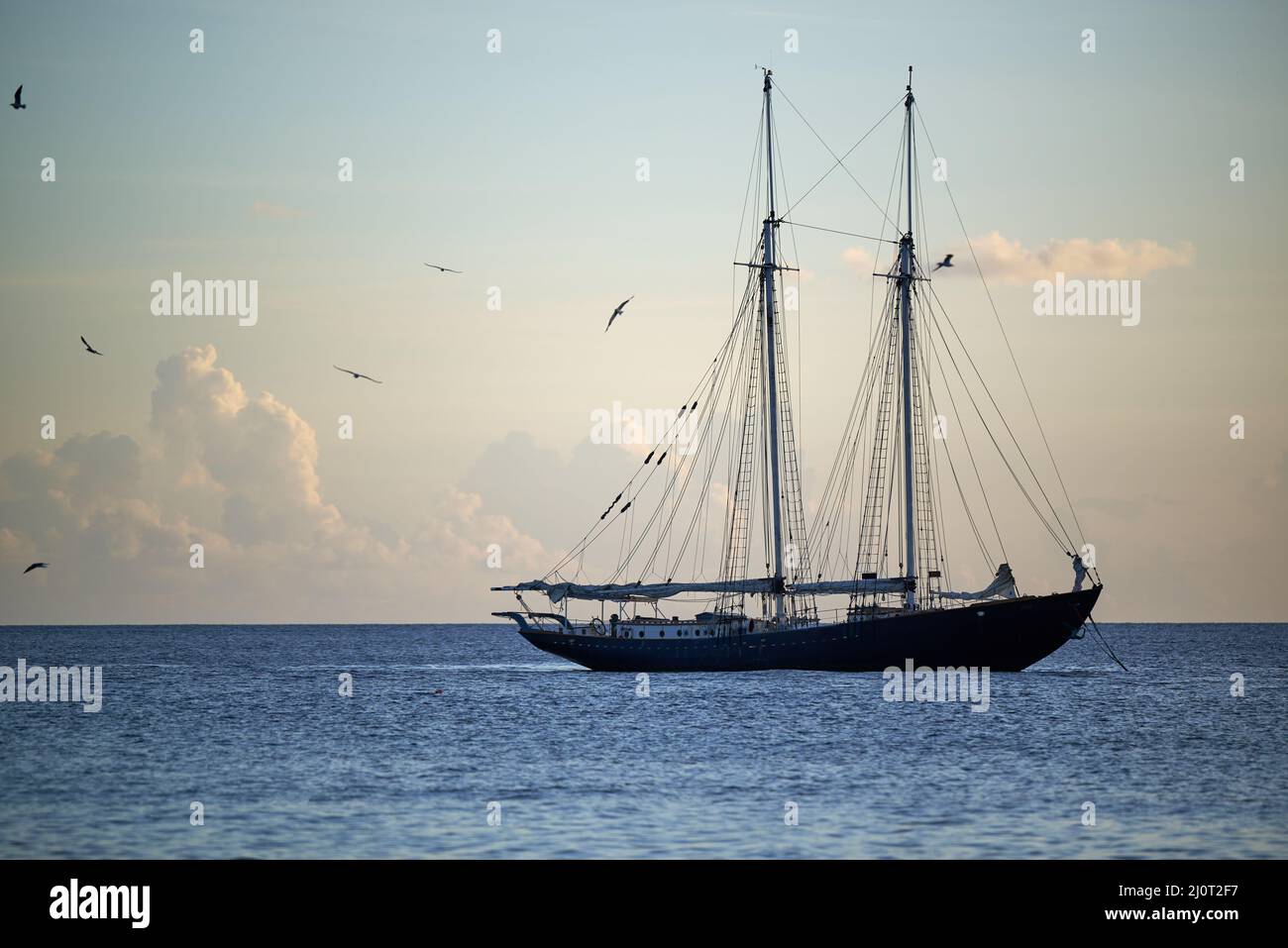 Scenic view of a ship sailing in the blue ocean on cloudy sky ...