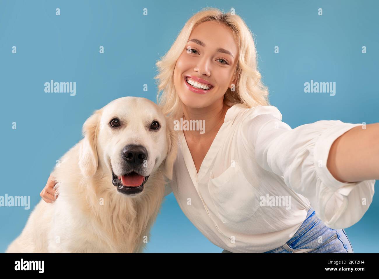 Young woman taking selfie with her happy dog Stock Photo