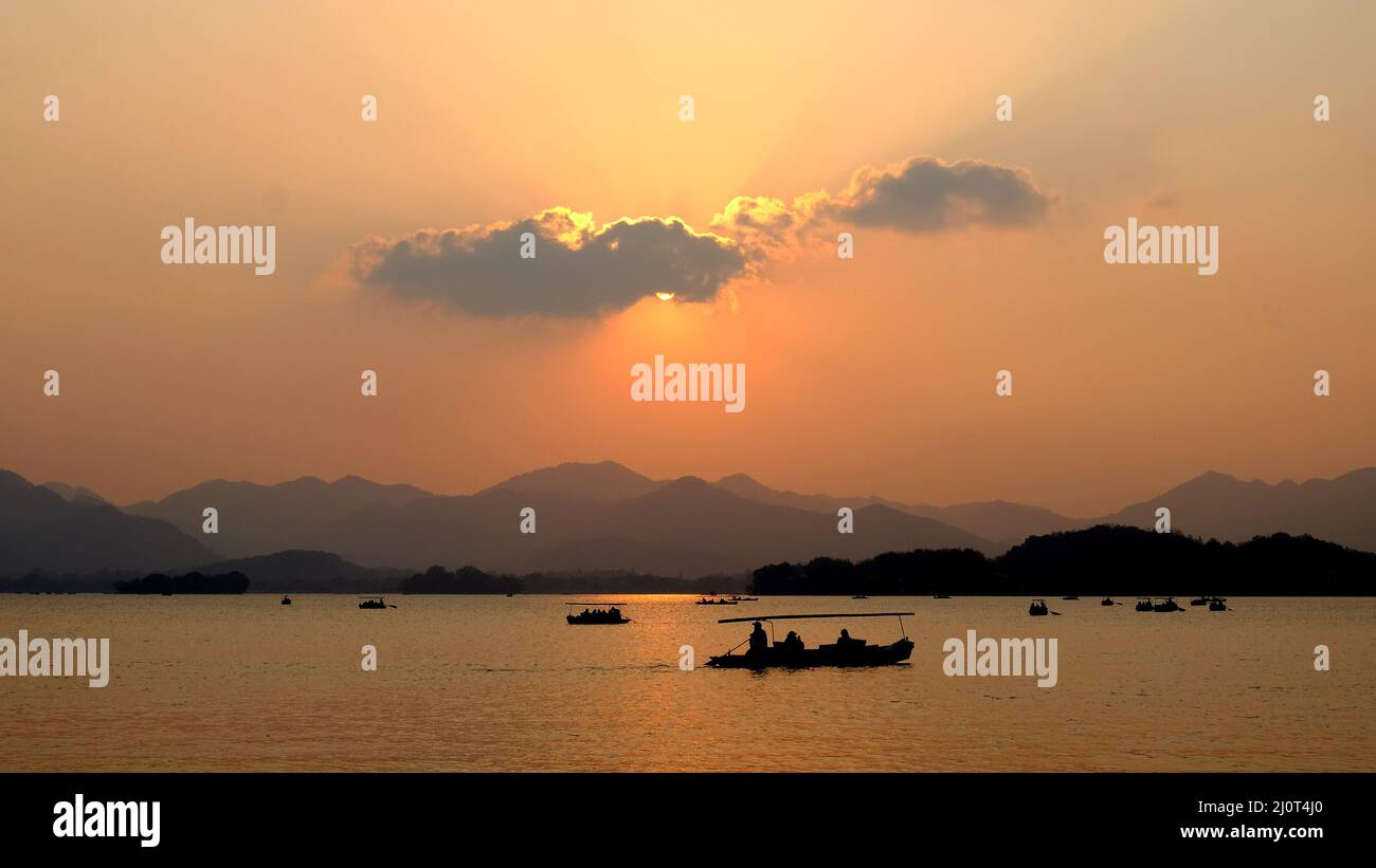 Silhouette of boat in the lake at sunset Stock Photo - Alamy