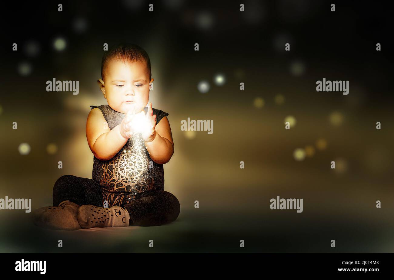 Shining Light in Hands of Little Cute Baby Stock Photo