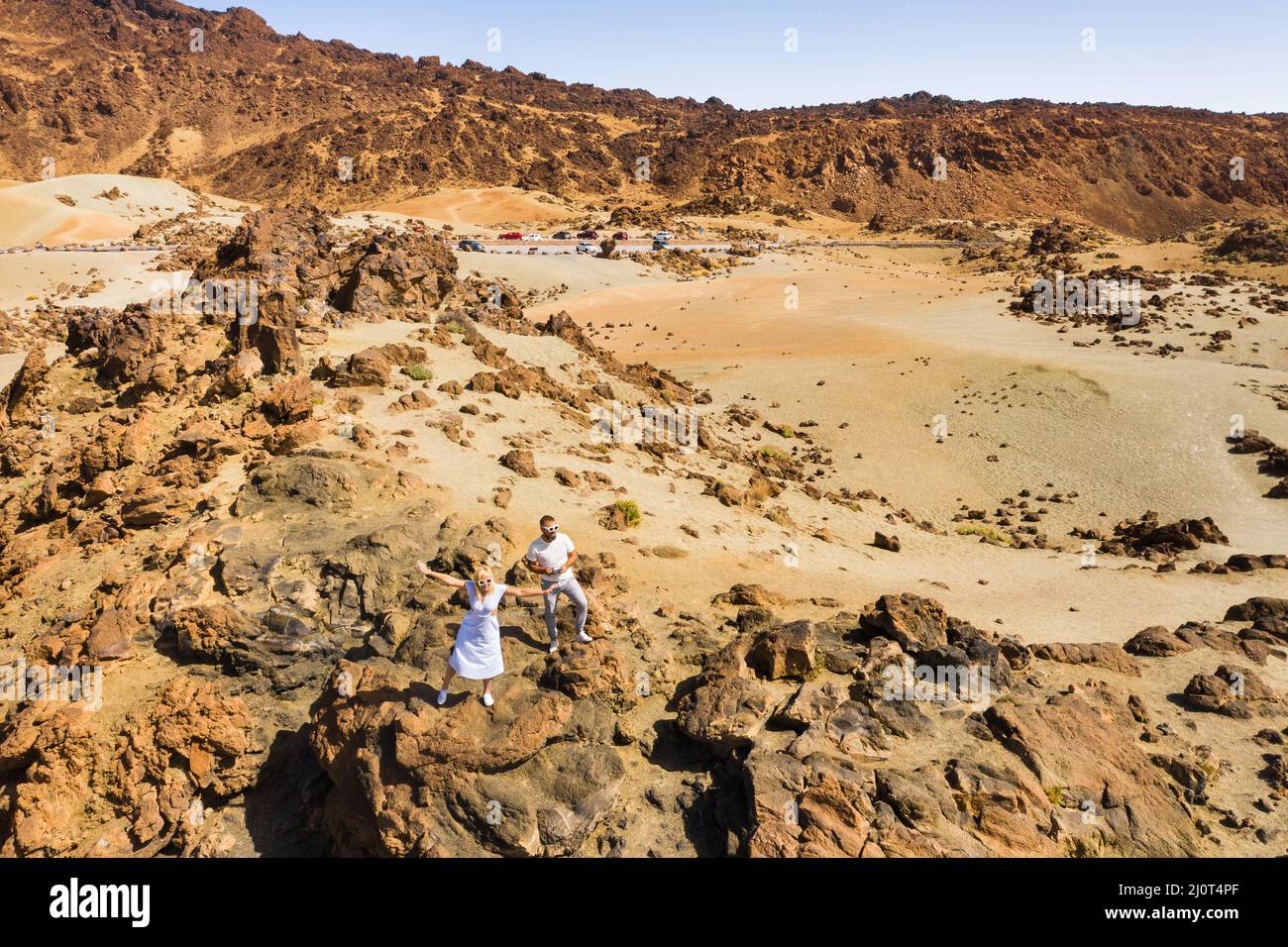 A couple in love stands in the crater of the Teide volcano. Desert landscape in Tenerife. Teide National Park. Tenerife, Spain. Stock Photo