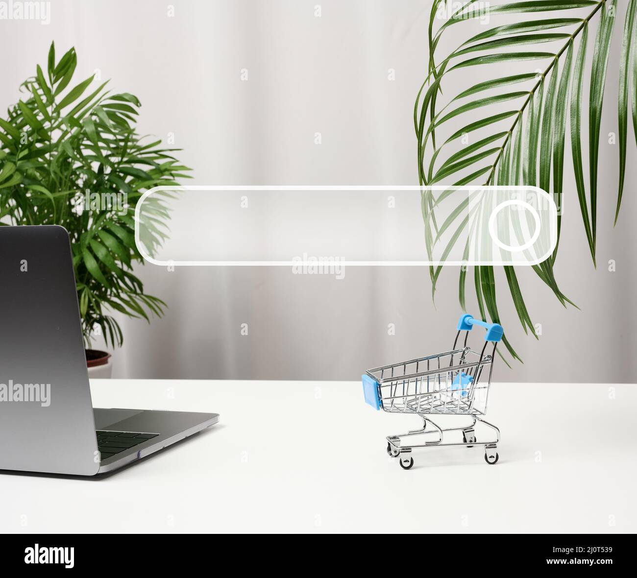 Empty miniature shopping carts on white desk. Seasonal sale, online shopping Stock Photo