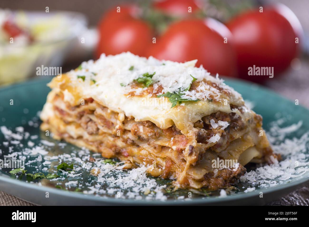 Portion of lasagna on a green plate Stock Photo