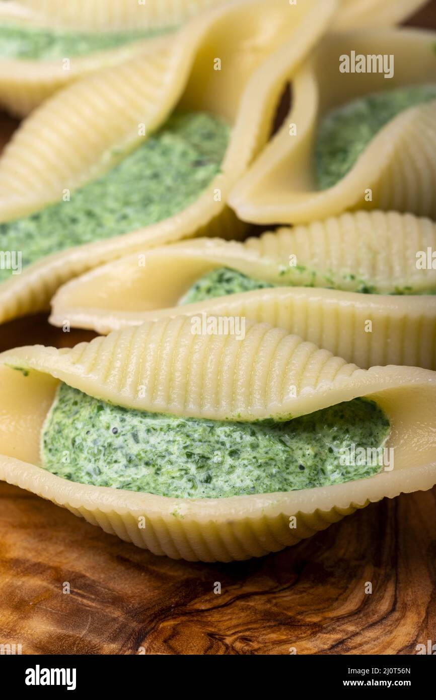Italian conchiglino pasta filled with spinach Stock Photo